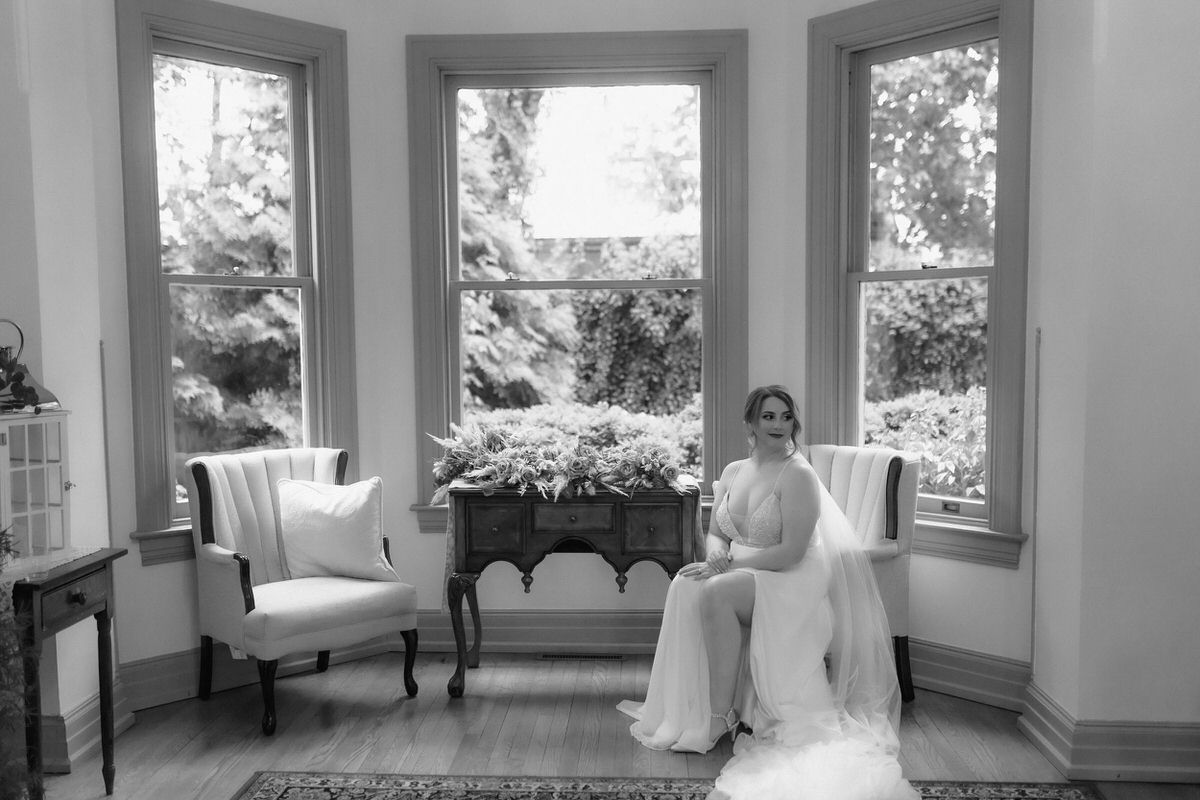 Celebrant sitting in a small nook with windows behind