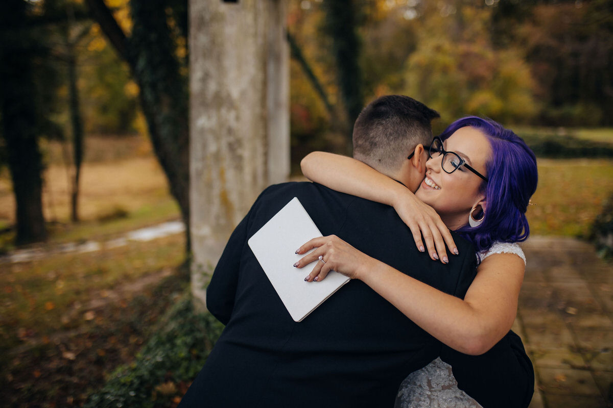 Celebrants hugging while one is holding a letter