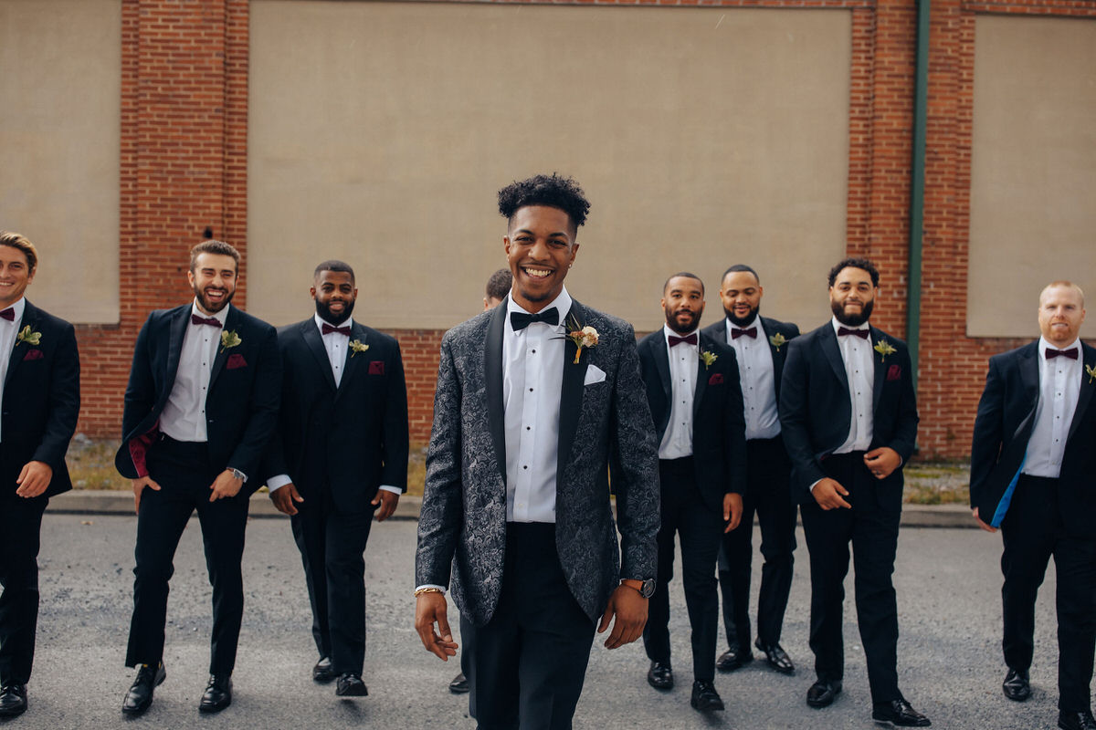 Celebrant smiling with wedding party standing behind them