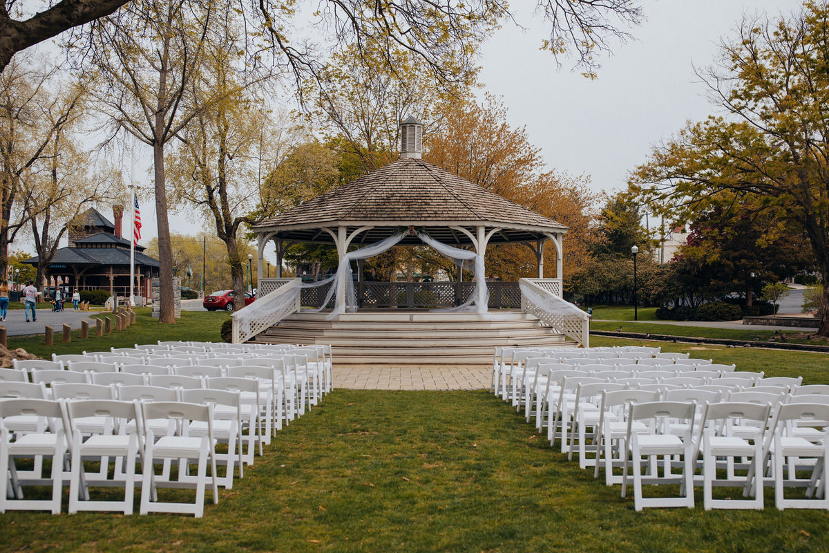gazebo with set of chairs set up on either side of an aisle 