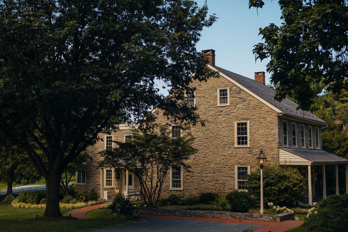 front of a stone building with trees in front