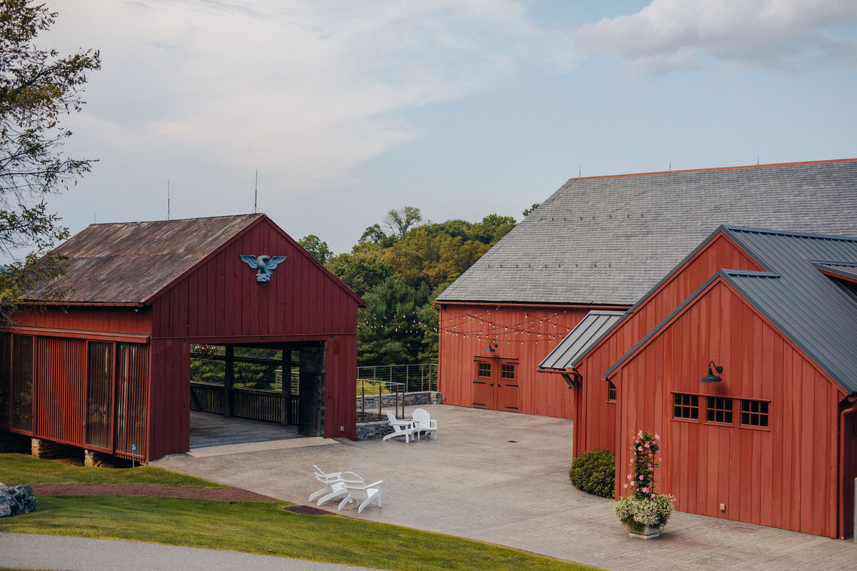 red barn and covered bridge with small patio in the middle