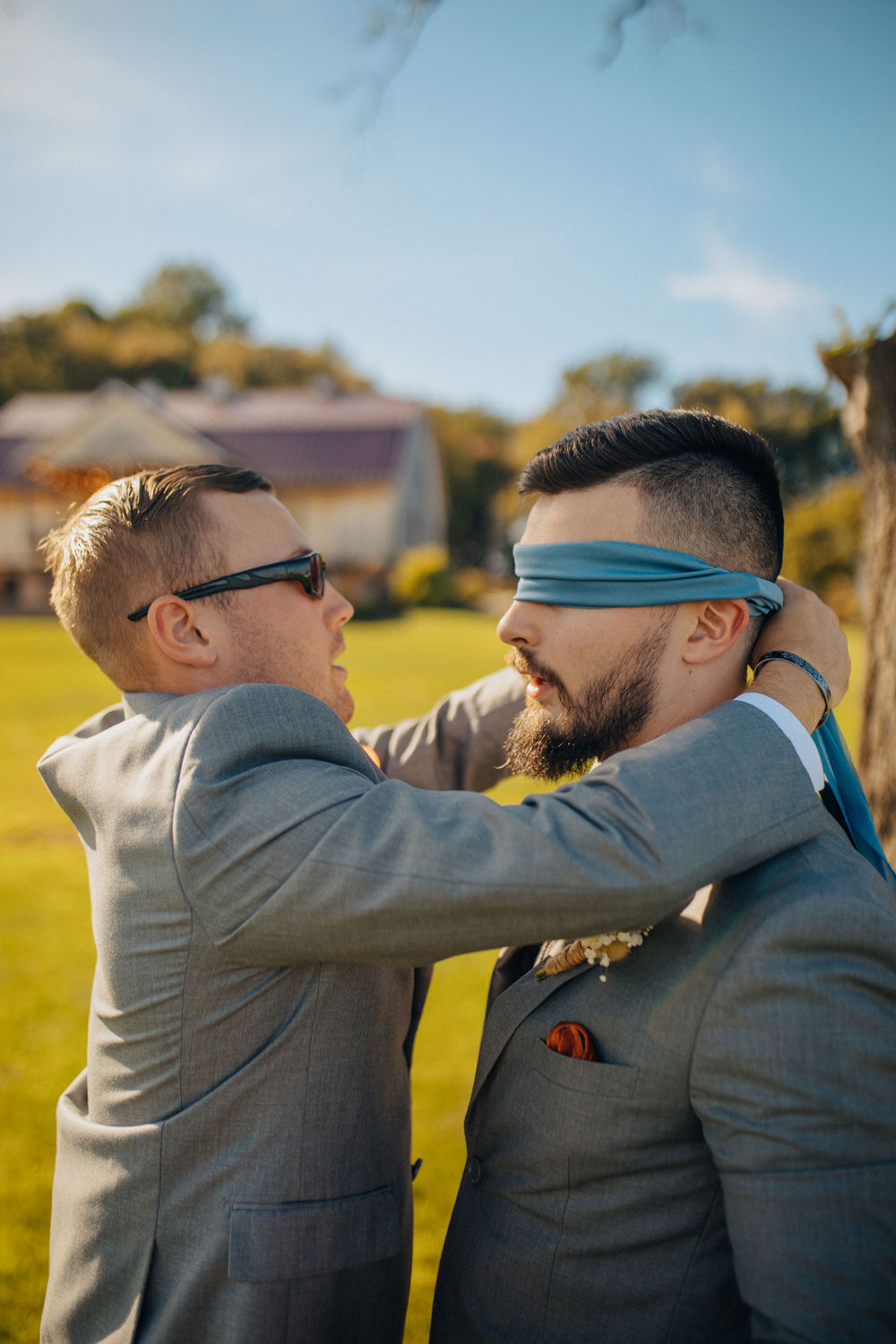 Celebrant being blindfolded by a friend for a first look.