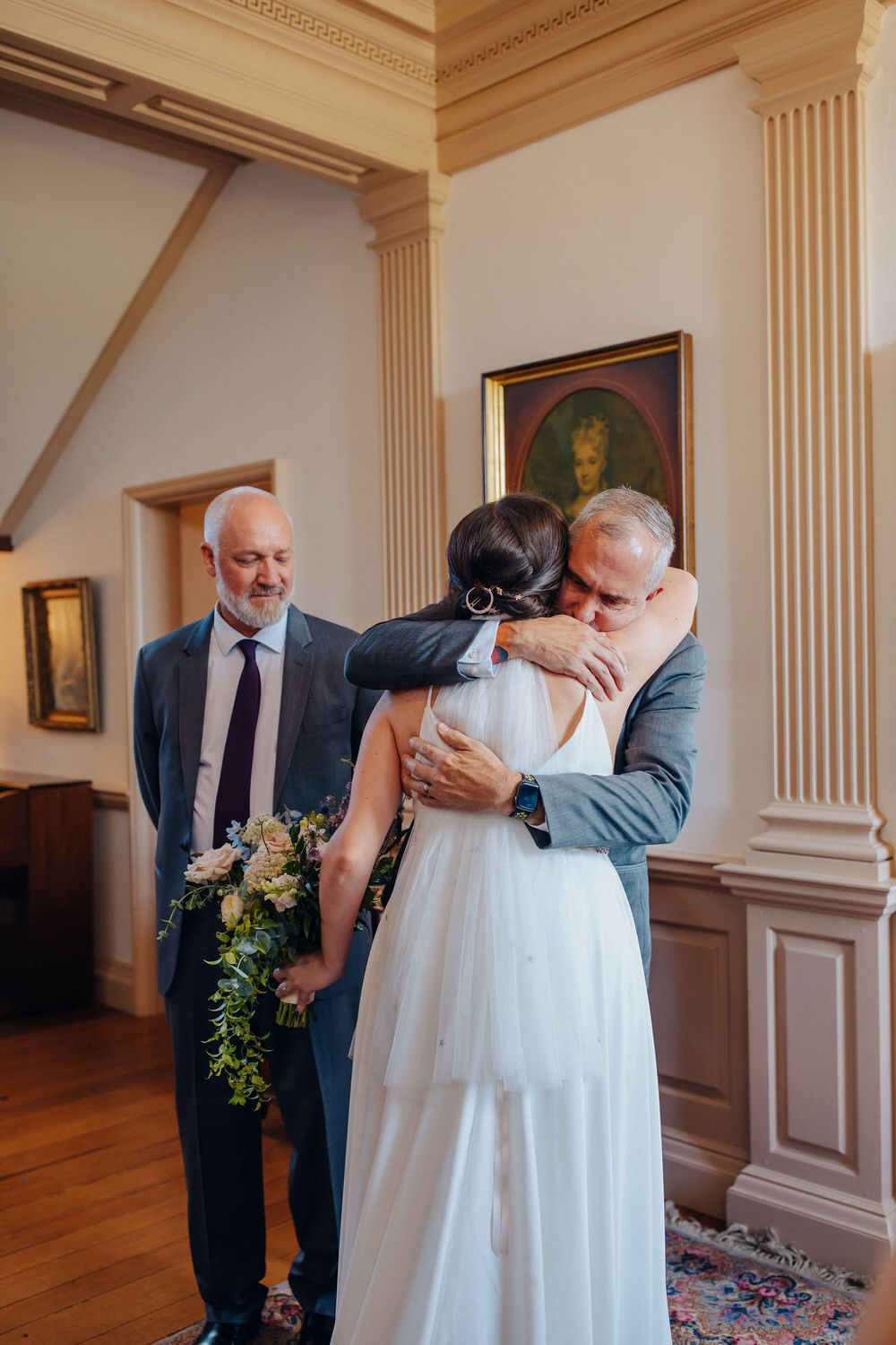 Two people hugging during a first look.