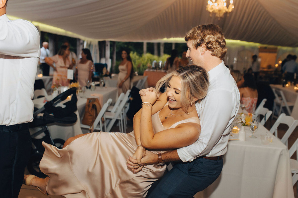 couple dancing at the reception and laughing