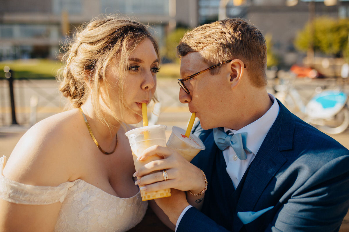 wedding couple drinking a bubble tea while crossing arms