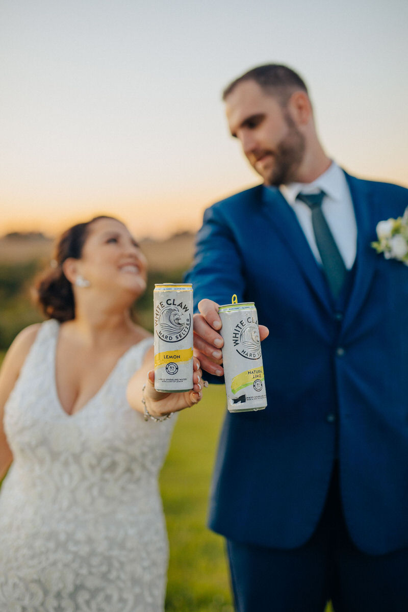 couple holding out a white claw 
