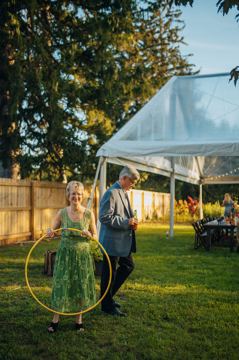 person holding a hola hoop with another person standing behind them at an outdoor reception