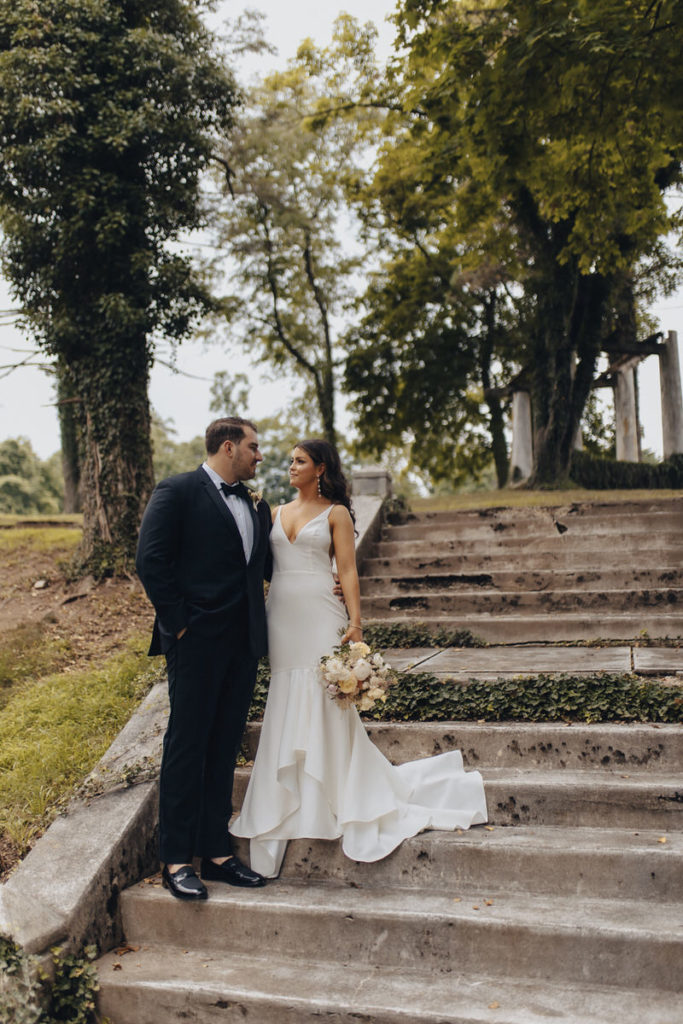 wedding couple standing on an outdoor staircase