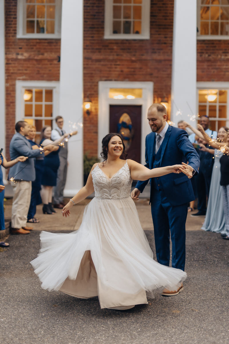 couple dancing in between wedding guests