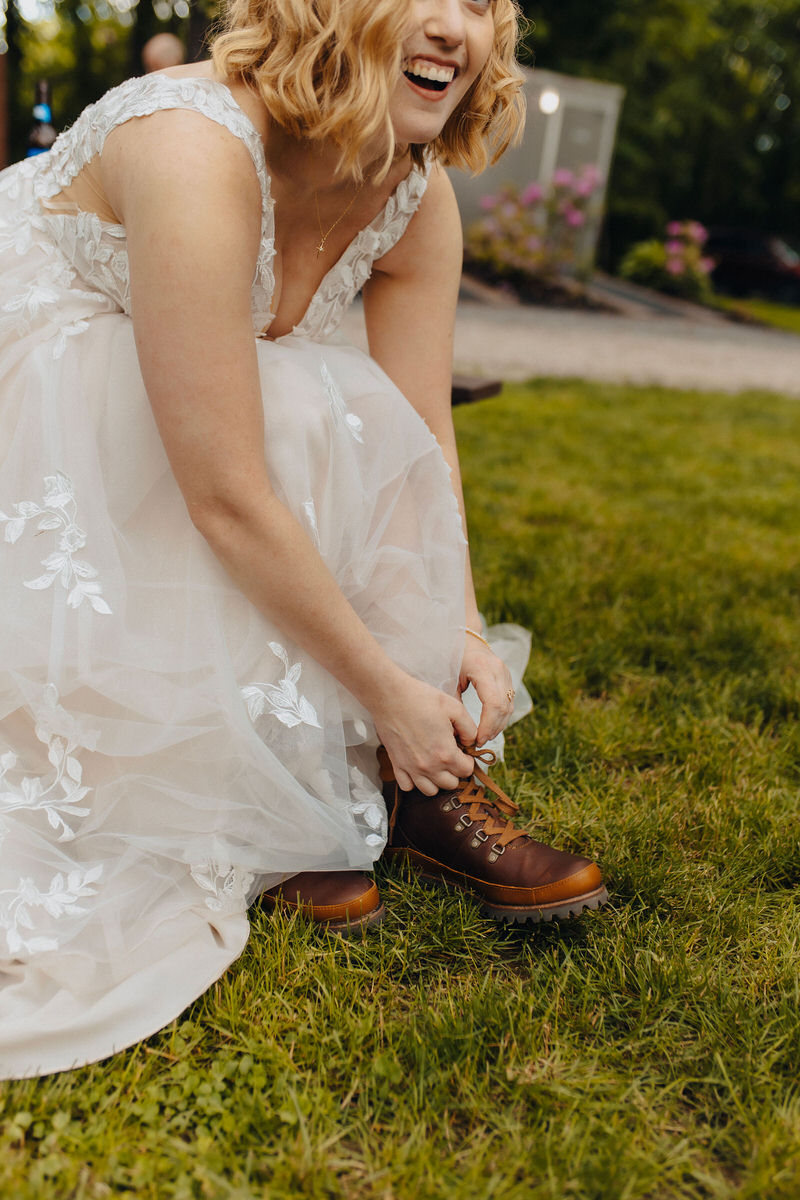 person tying boot under their dress 