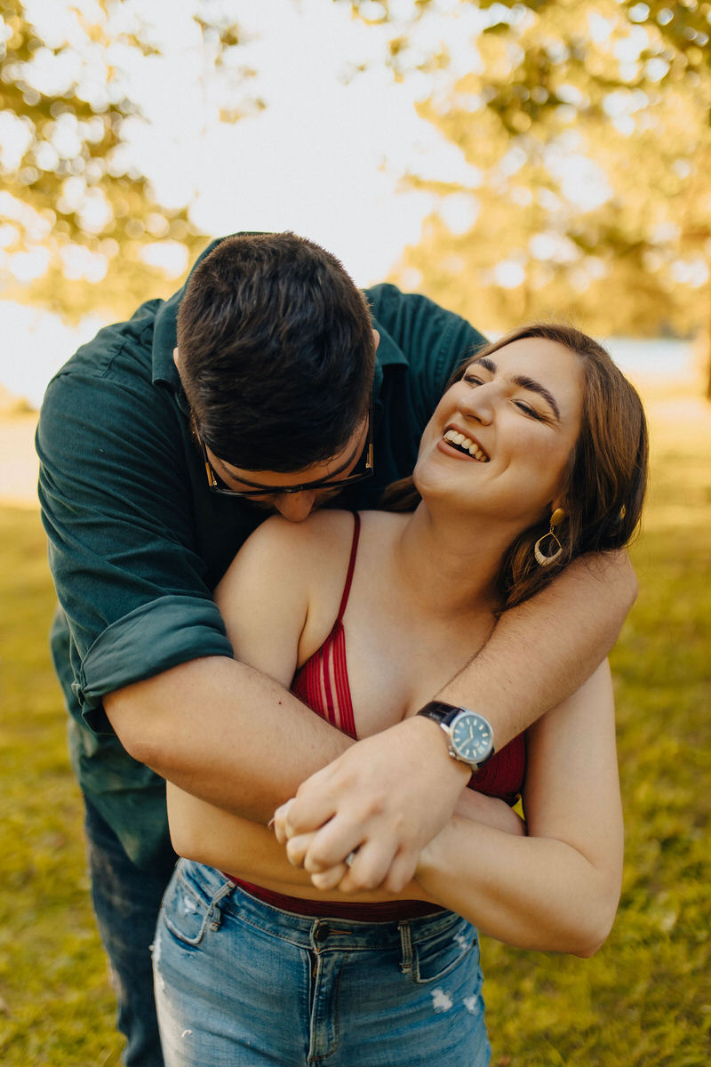couple hugging from behind and laughing