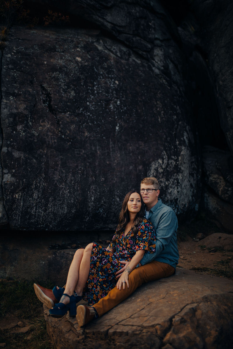 couple sitting on a large rock together