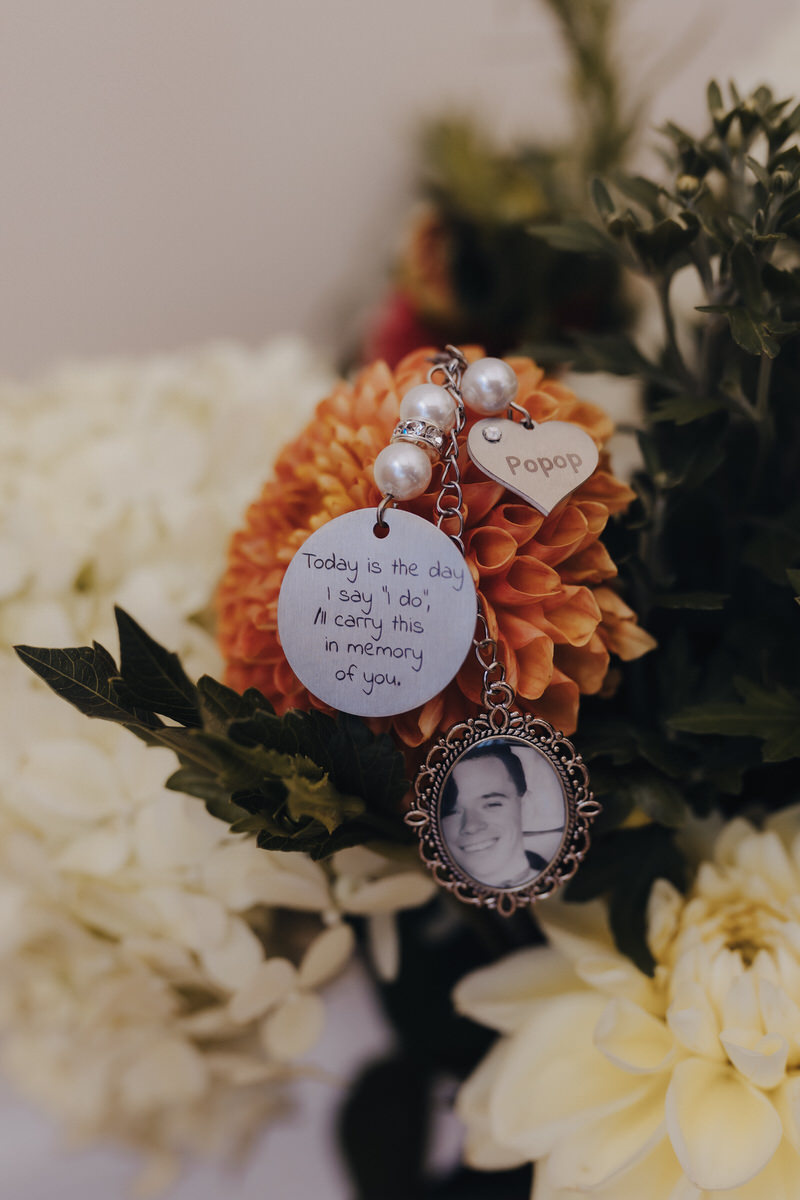 locket with a picture hanging off of flowers