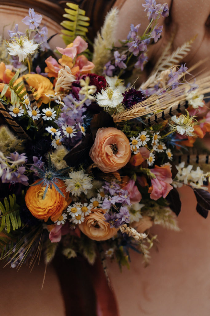 an orange purple and pink bouquet of flowers