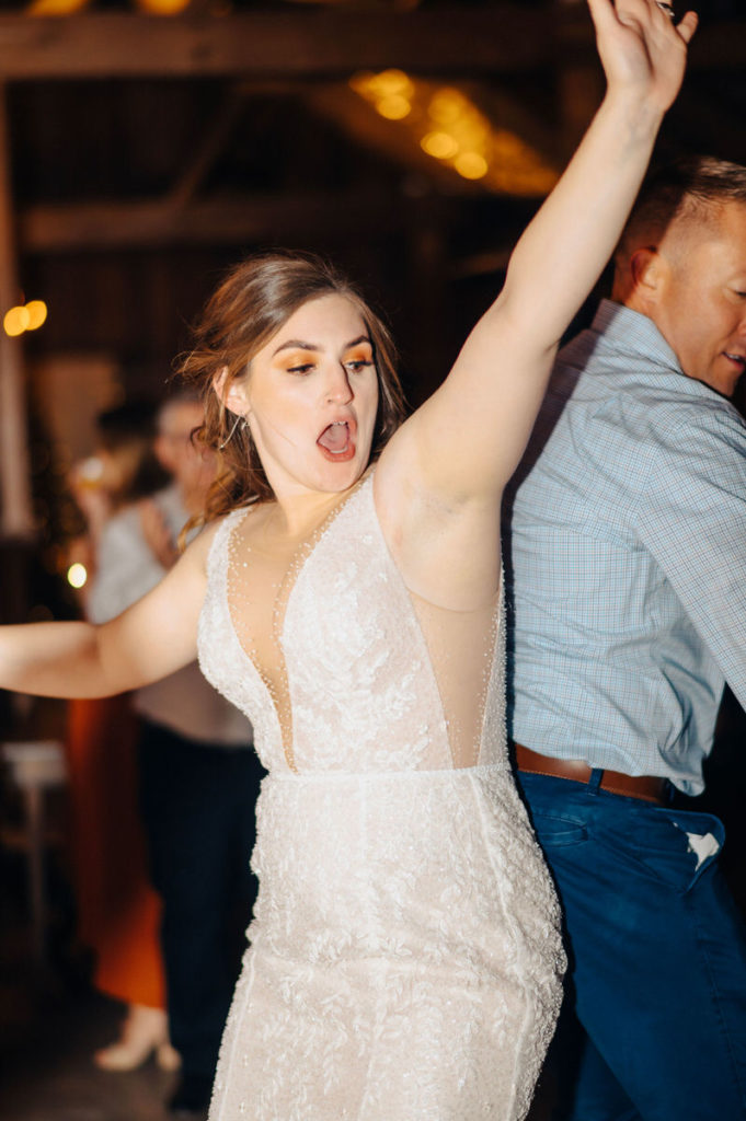 newlywed dancing with someone at their reception
