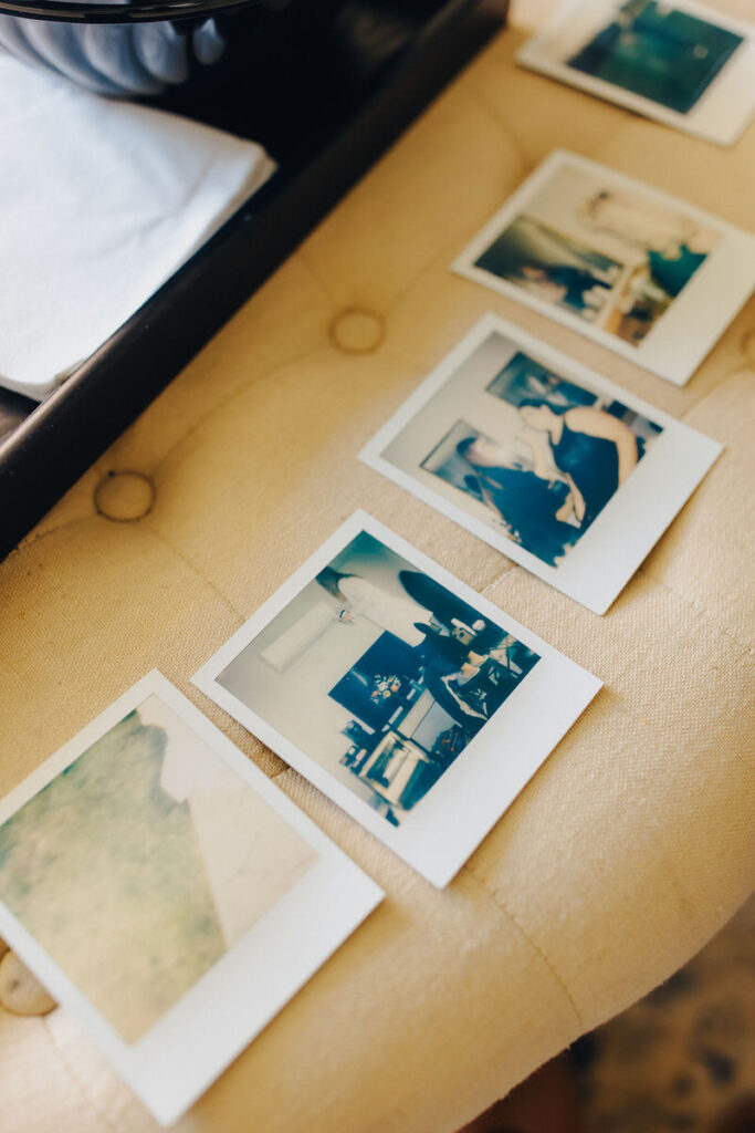 An array of instant photos spread out on an ivory lace surface, capturing candid moments and scenic views