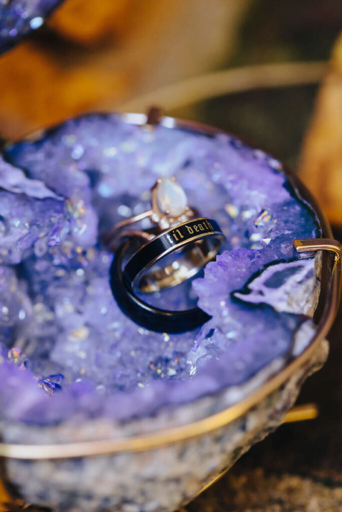 Wedding and engagement rings say in a purple rock. 