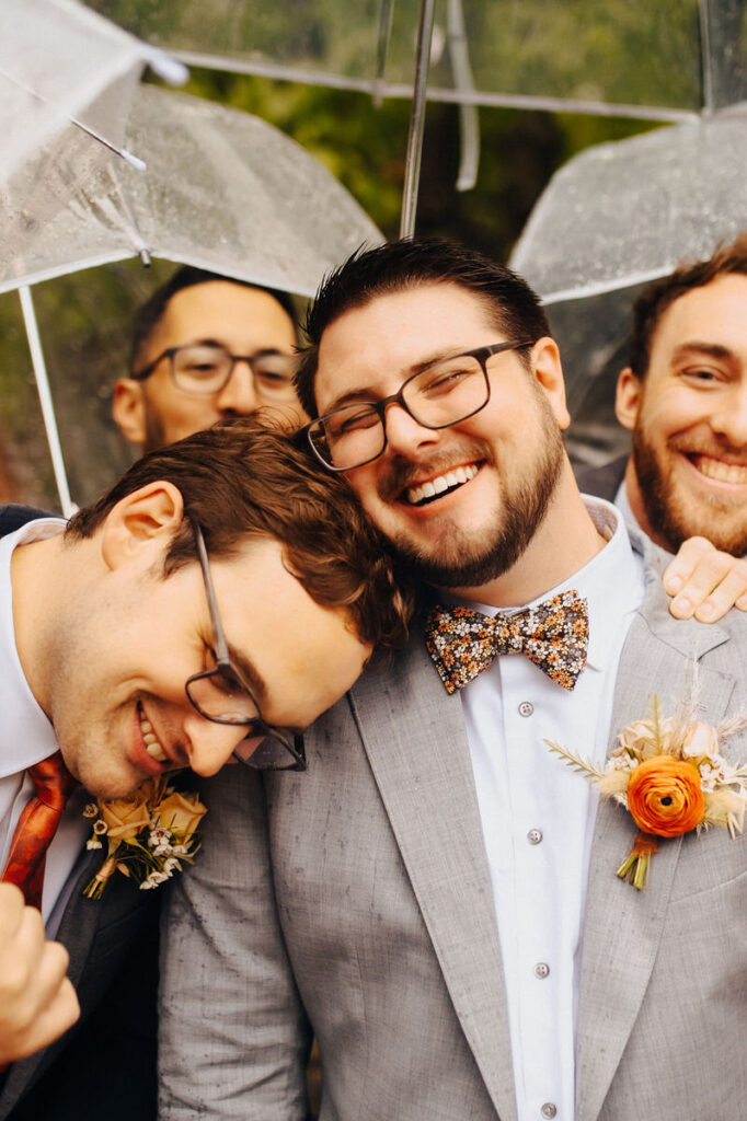 A person surrounded by their wedding party as they smile. 
