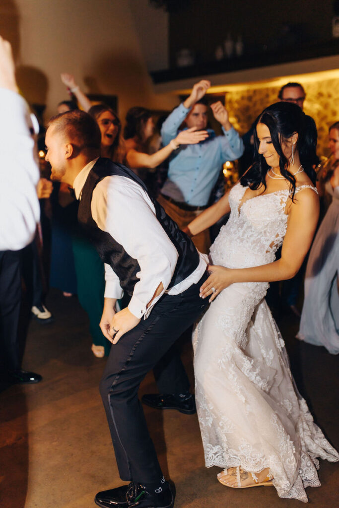 A newlywed couple dancing at their reception 
