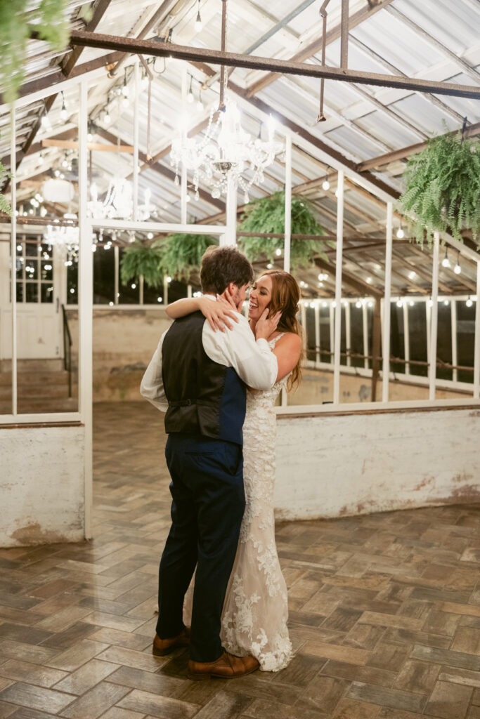 A newly-wed couple laughing and dancing privately at the end of their wedding night